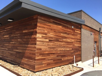 Tropical hardwood siding displaying natural variations in grain and rich brown color